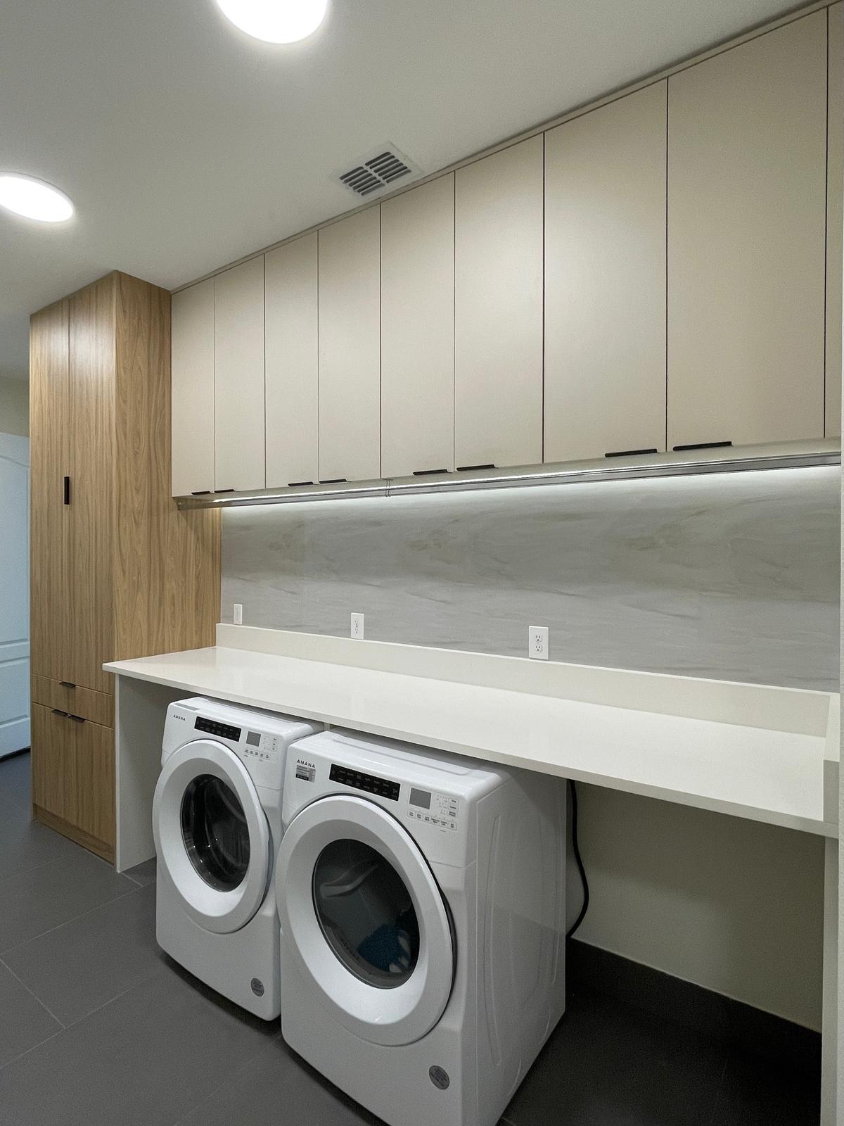 Polished laundry with custom cabinetry